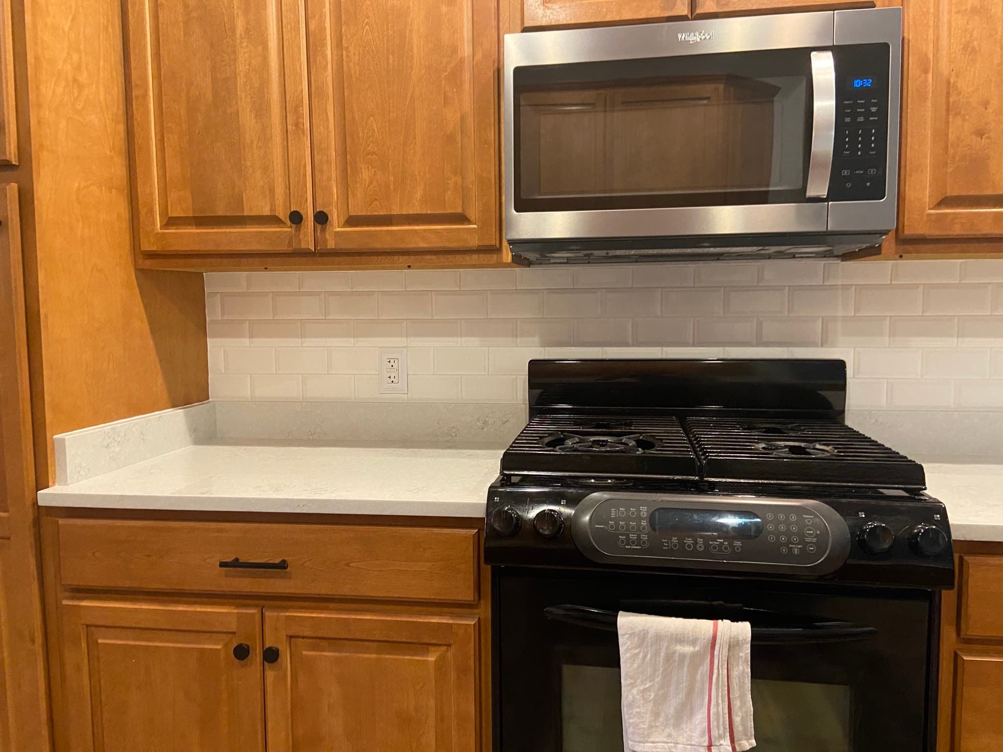 Kitchen with wooden cabinets and black gas range
