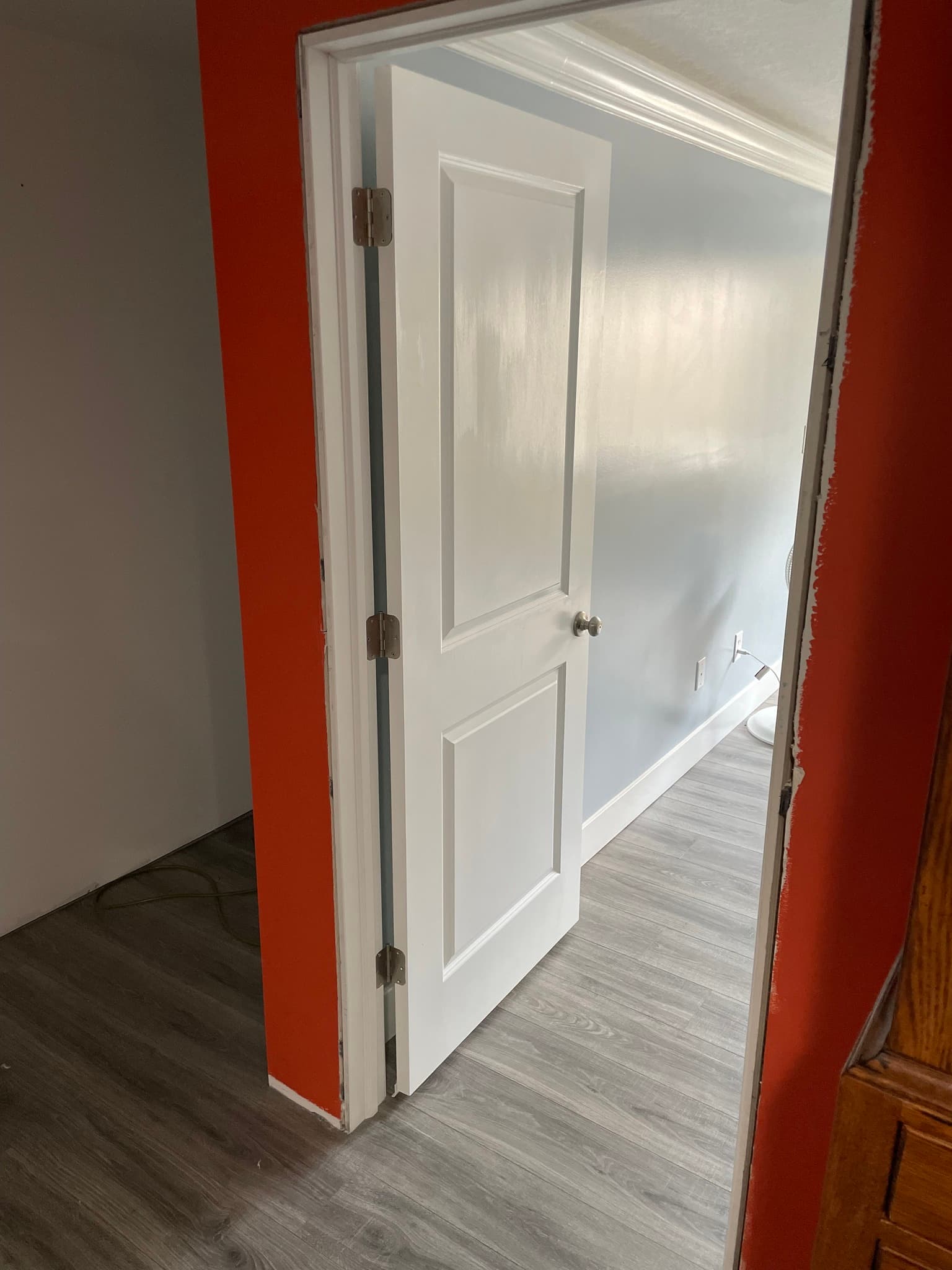 White two-panel interior door with brass hardware
