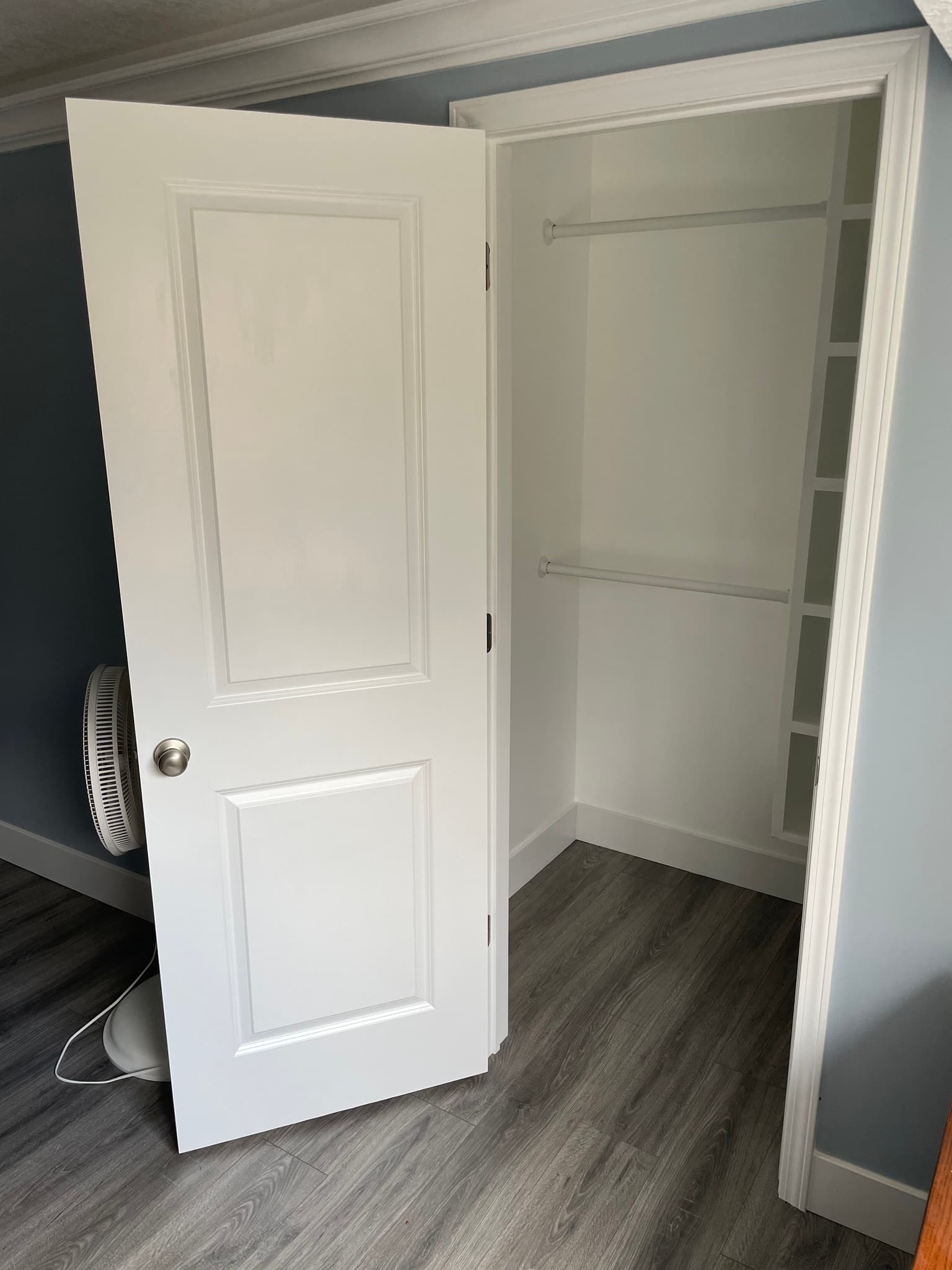 White closet doors showing empty shelving interior