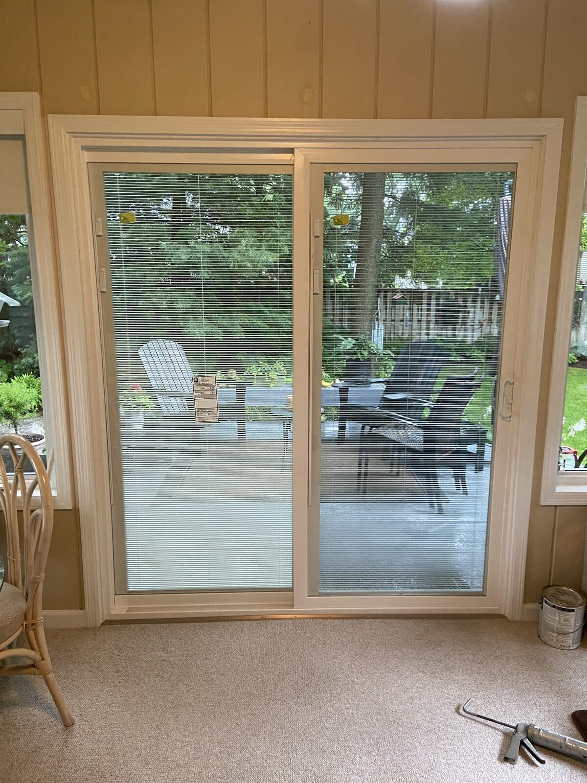 Replacement sliding patio door overlooking landscaped backyard
